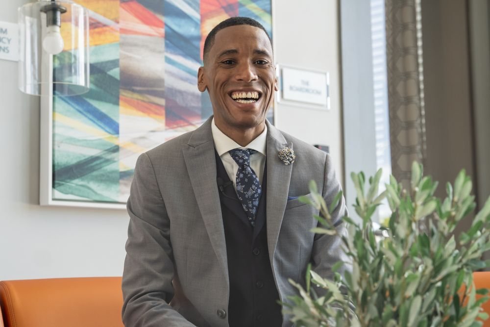Portrait of a smiling executive in a grey suit