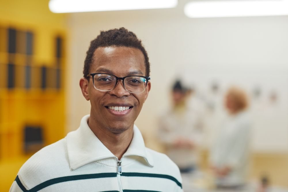 Portrait of a smiling founder in glasses