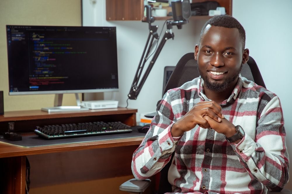 Smiling developer at his workstation