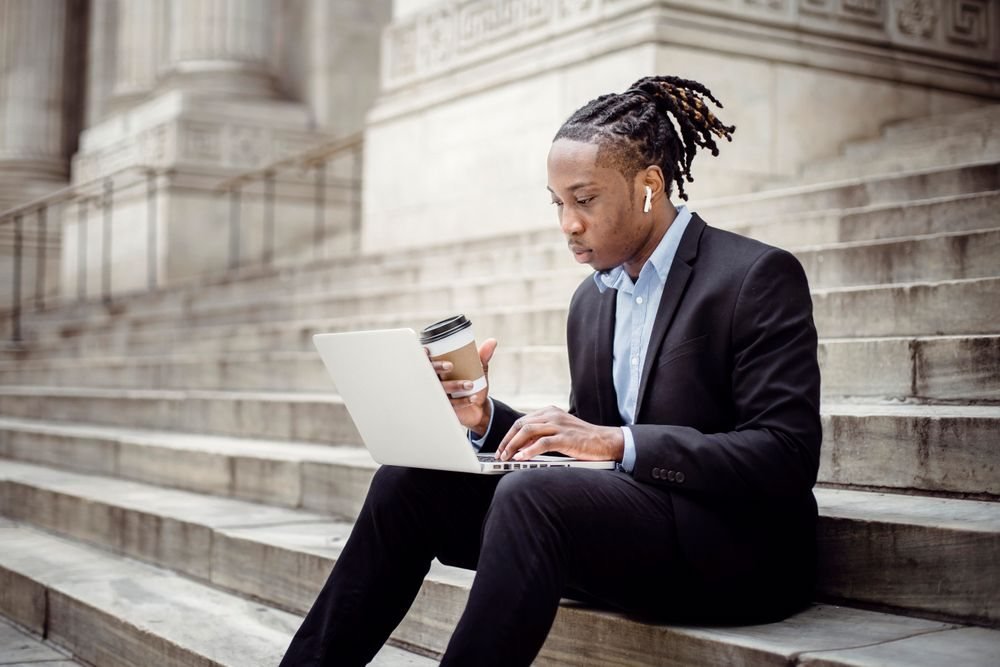 Founder working on a laptop outdoors