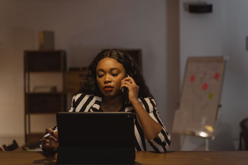 Professional on a call while working on her laptop