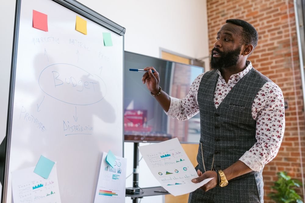 Trainer presenting a strategy at a whiteboard