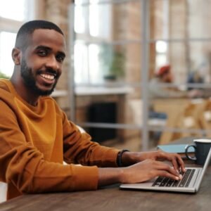 Smiling entrepreneur working on his laptop