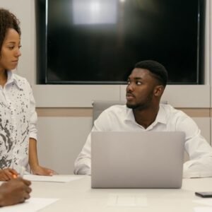 Colleagues discussing at a desk