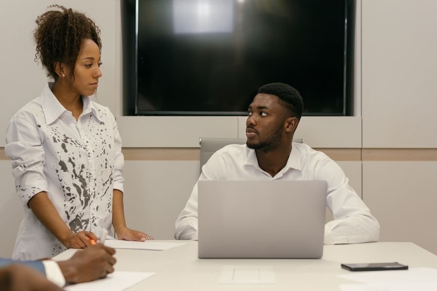Colleagues discussing at a desk