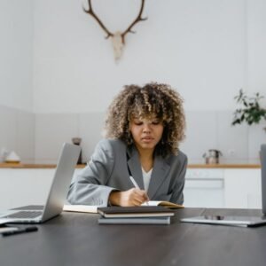 Consultant taking notes at a desk
