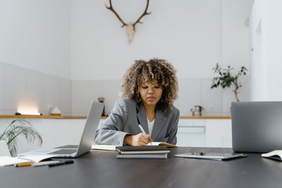 Consultant taking notes at a desk